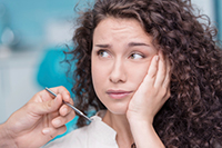 Young woman with toothache at dentist